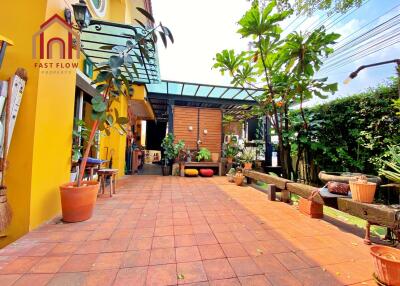 Spacious outdoor patio with plants and seating area