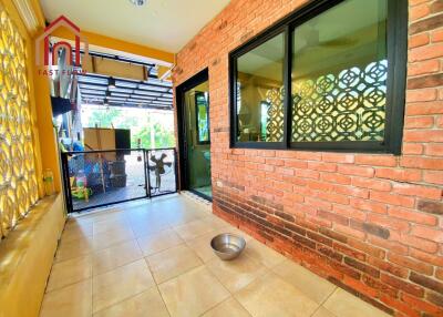 Outdoor patio area with brick wall and tiled floor