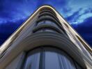 Modern high-rise building with architectural curves during twilight