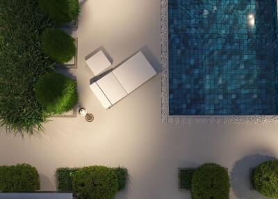 Aerial view of a stylish outdoor area with pool, lounger, and greenery