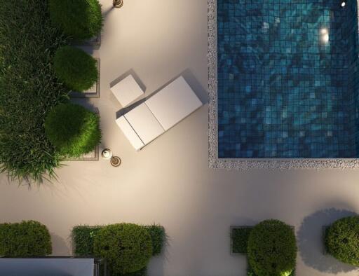 Aerial view of a stylish outdoor area with pool, lounger, and greenery