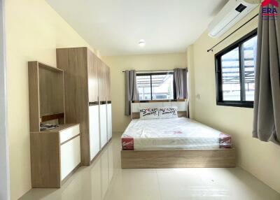 Modern bedroom with large windows and built-in wardrobe