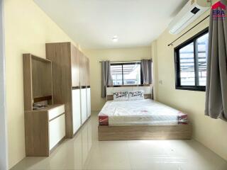 Modern bedroom with large windows and built-in wardrobe