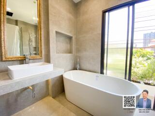 Modern bathroom with bathtub and vanity