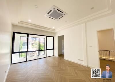 spacious living room with large windows and modern ceiling fixture