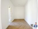 Empty room with wooden floor and white walls