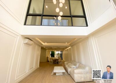 Spacious and modern living room with high ceiling and large windows