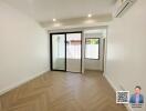 Empty living room with large sliding glass doors