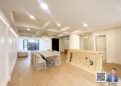 Spacious living and dining area with modern lighting and flooring