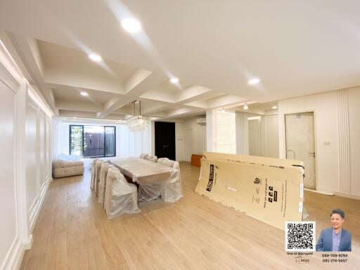 Spacious living and dining area with modern lighting and flooring