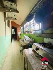 Narrow kitchen with stove and storage