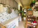 Narrow kitchen with wall-mounted utensils and storage shelves