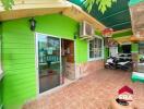 Exterior area of a property with green walls and a tiled floor