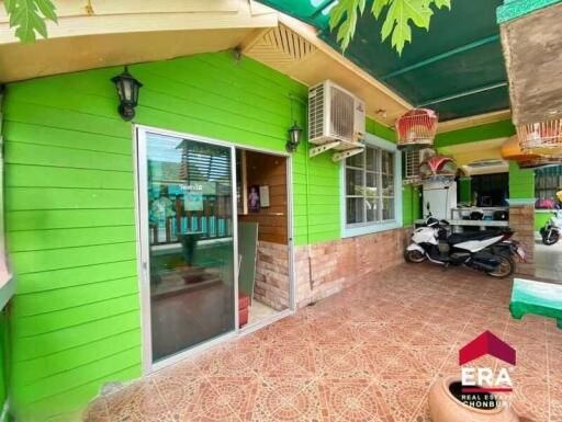 Exterior area of a property with green walls and a tiled floor