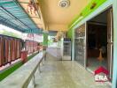 Covered outdoor area with tiled flooring and glass sliding door