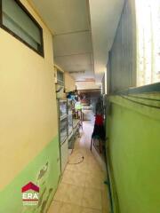 Narrow kitchen with visible appliances and storage