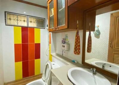 Bathroom with modern fixtures and vibrant colored tiles