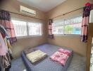 Cozy bedroom with large windows and air conditioning