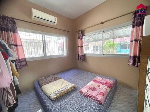 Cozy bedroom with large windows and air conditioning