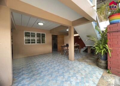 Outdoor patio area near stairs with table and chairs