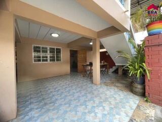 Outdoor patio area near stairs with table and chairs