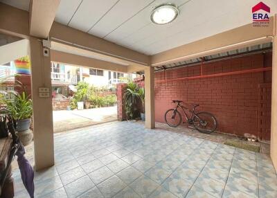 Covered outdoor area with tiled floor, ceiling light, and bicycle