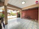 Covered outdoor area with tiled floor, ceiling light, and bicycle