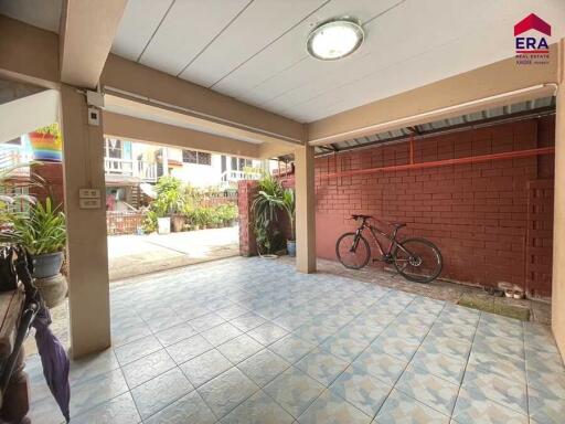 Covered outdoor area with tiled floor, ceiling light, and bicycle