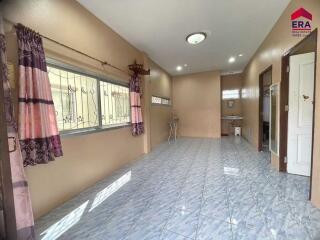 Spacious main living area with tiled flooring and large windows