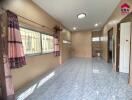 Spacious main living area with tiled flooring and large windows