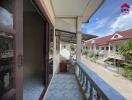 Balcony view with a street and neighboring houses