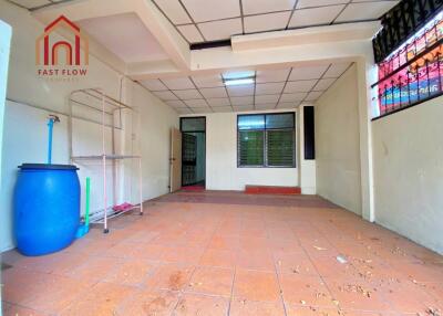 Empty indoor space with tiled floor and ceiling grid