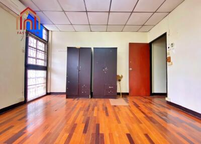 Spacious bedroom with wooden floor and wardrobes