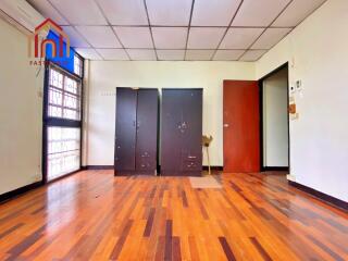 Spacious bedroom with wooden floor and wardrobes