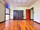 Spacious bedroom with wooden floor and wardrobes