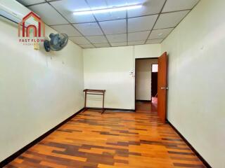 Empty room with wooden floor and ceiling fan