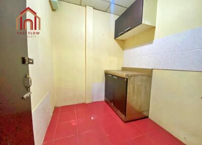 Compact kitchen with red tile flooring