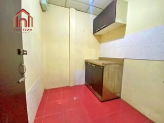 Compact kitchen with red tile flooring