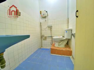 Simple bathroom with blue tiles and toilet