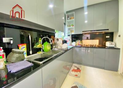 Modern kitchen with grey cabinetry and black countertops