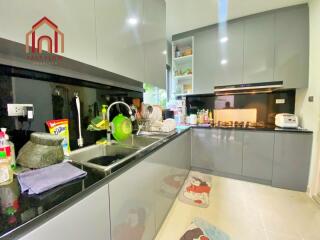 Modern kitchen with grey cabinetry and black countertops