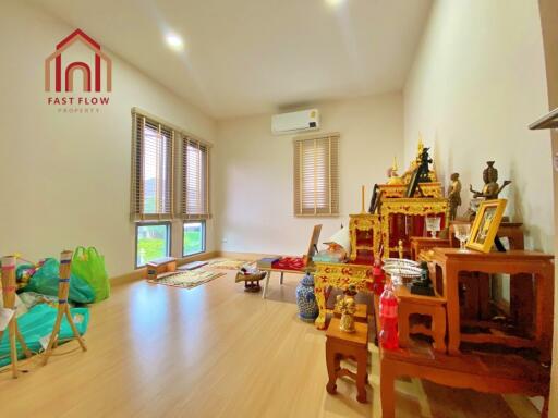 Bright living room with wooden flooring and traditional decorations