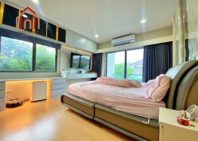 Modern bedroom with large windows and ample natural light