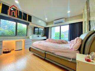 Modern bedroom with large windows and ample natural light