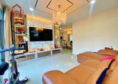 Modern living room with chandelier and large TV