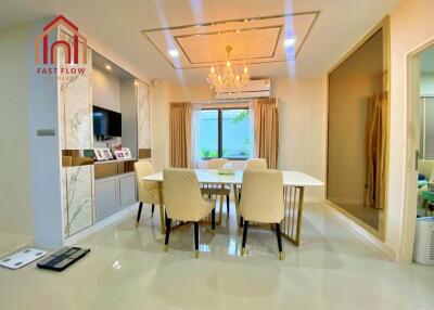 Modern dining room with chandelier and marble accents