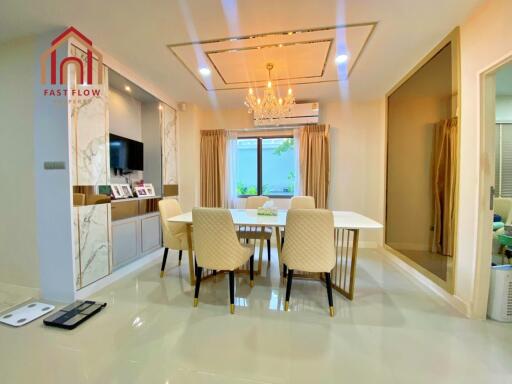 Modern dining room with chandelier and marble accents