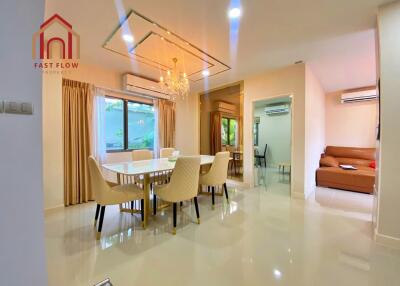 Modern dining room with chandelier and large window