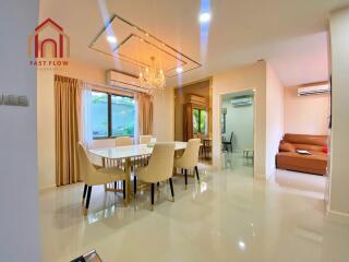 Modern dining room with chandelier and large window