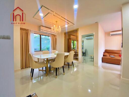 Modern dining room with chandelier and large window